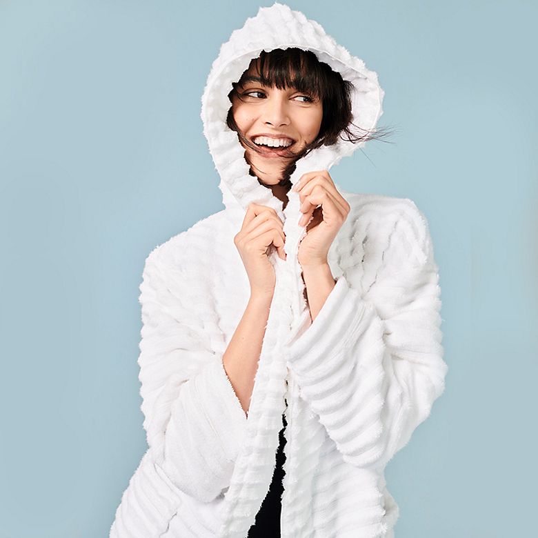 Woman wearing white ribbed towelling dressing gown