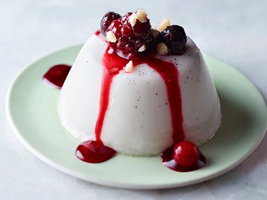 panna cotta topped with frozen fruit and berries
