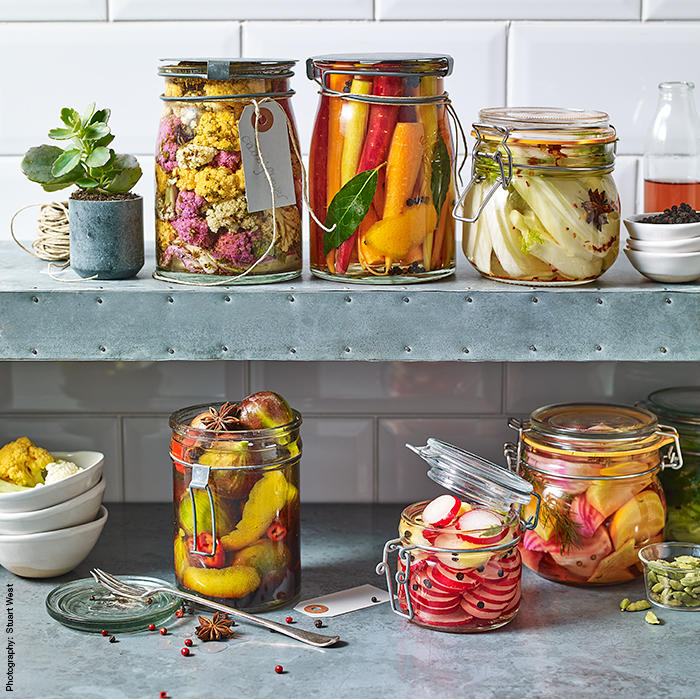 A selection of kilner jars filled with colourful pickled fruits and vegetables