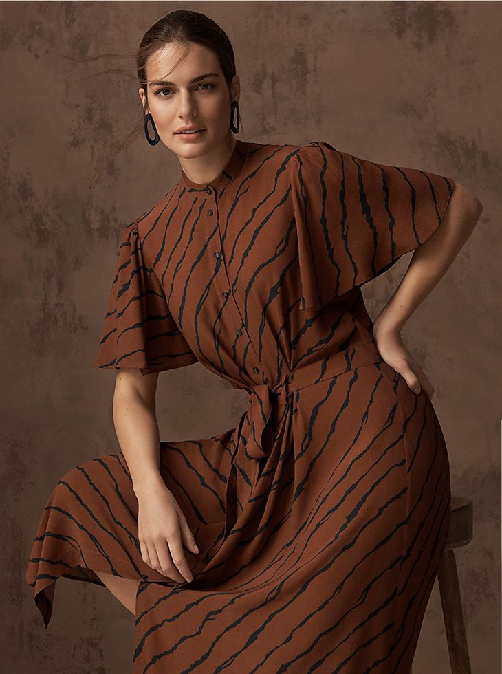 Model wears a brown tiger-print midi dress