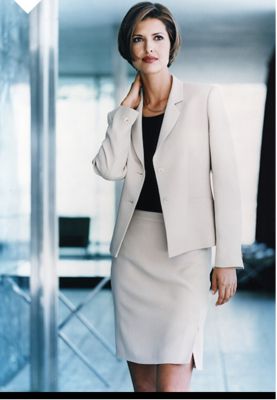 Woman wearing a beige skirt suit in the office, 1999