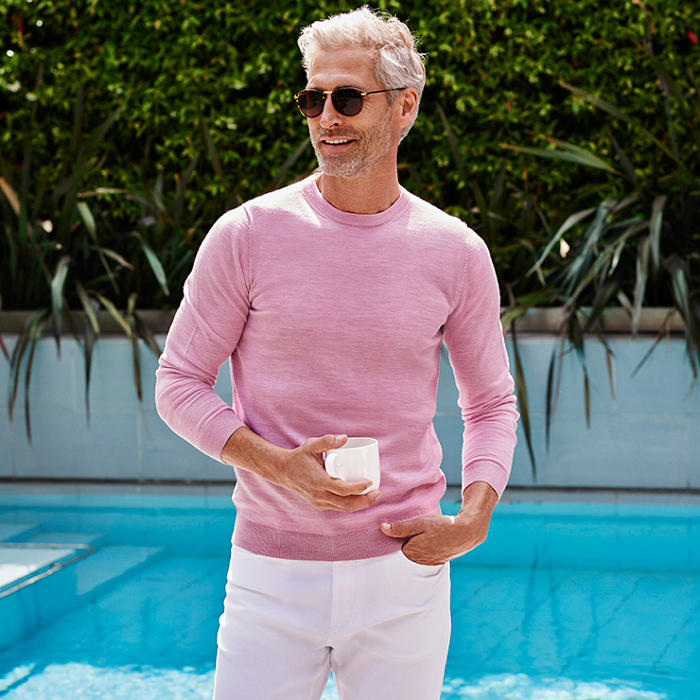 Man wearing pale pink jumper made from merino wool