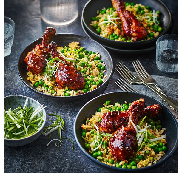 Three bowls with teriyaki chicken drumsticks and egg-fried rice