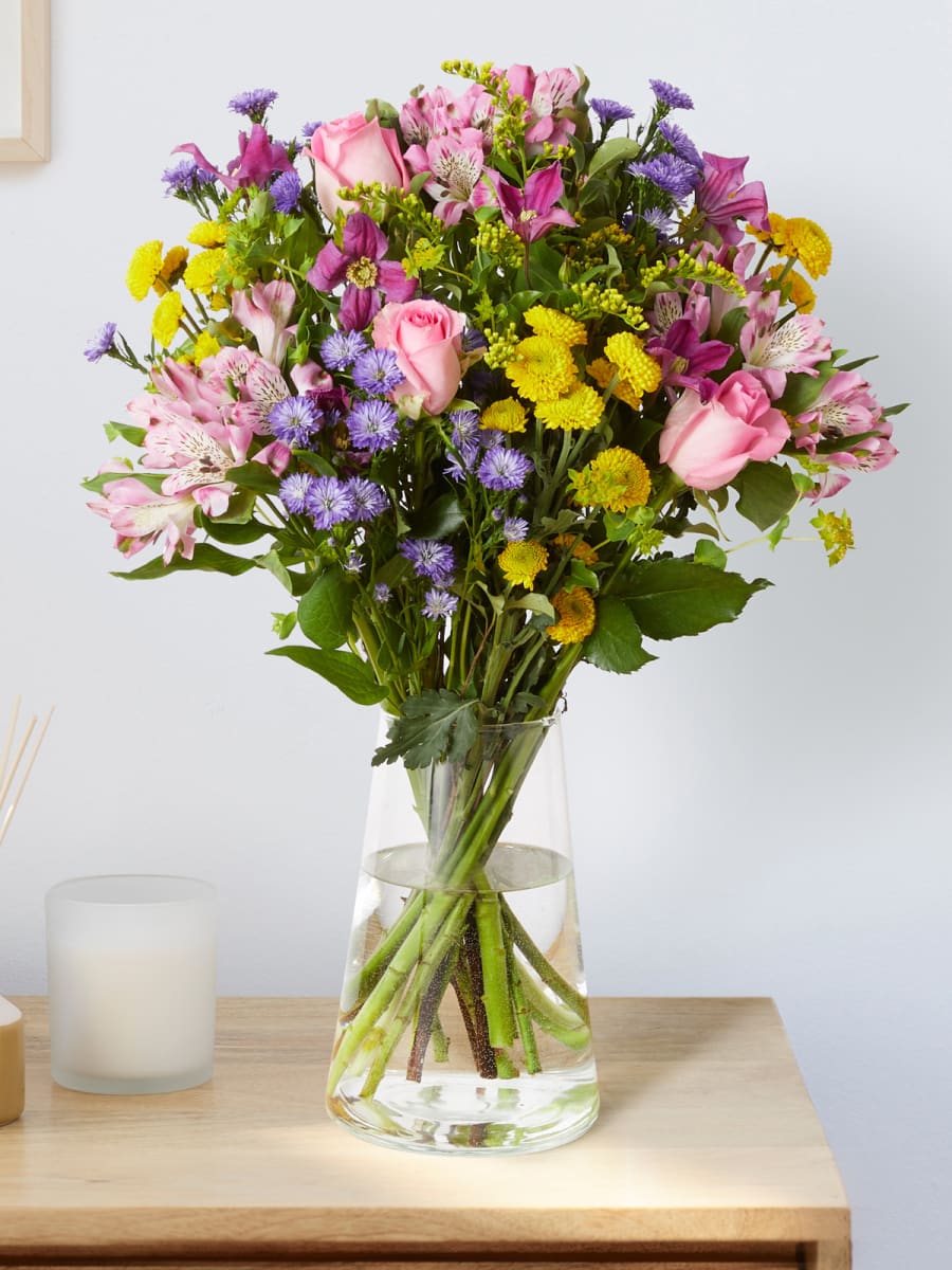 Colourful flower bouquet on a sideboard. Shop flowers