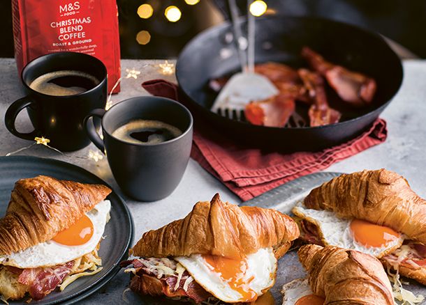 Coffee and croissants filled with bacon and egg