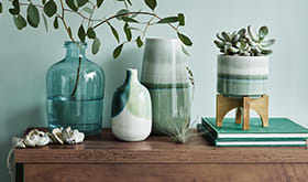 Wooden console table with green accessories