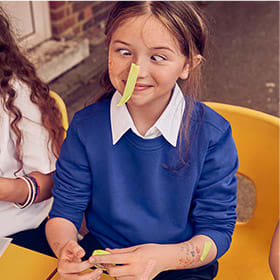 Girl wearing M&S school jumper with StayNew technology