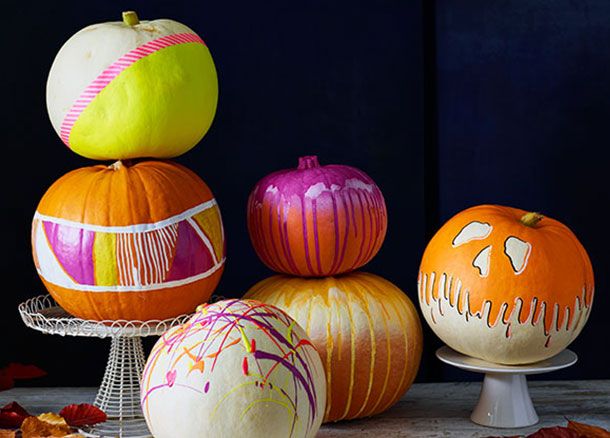 A group of colourful painted pumpkins