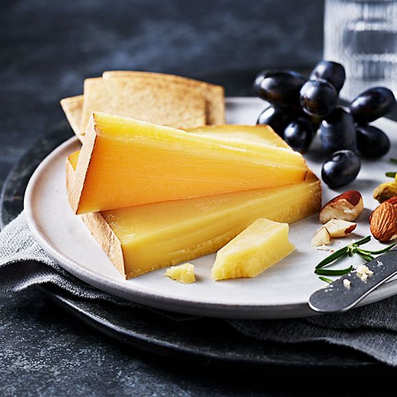 Wedges of Comté cheese with black grapes