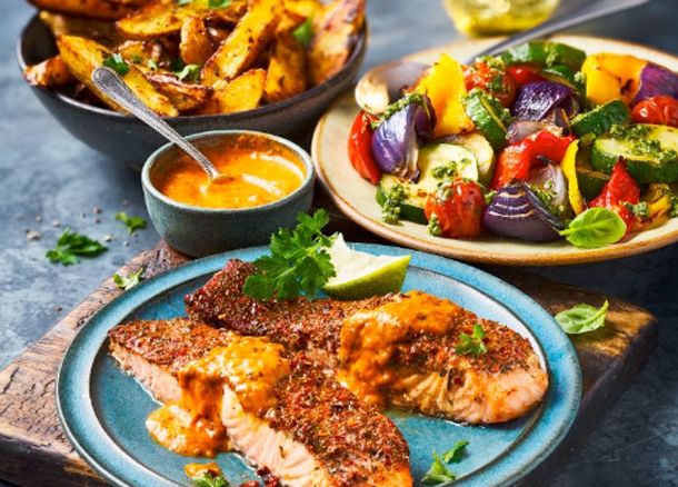 Cajun-style salmon with roasted vegetables and potato wedges