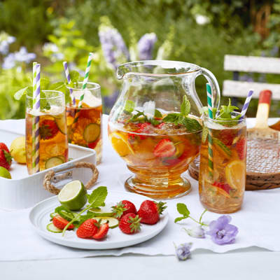 Jug and glasses of summer cup cocktail