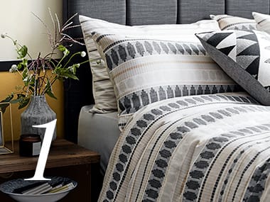Patterned bed set next to bedside table