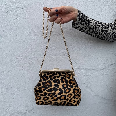 M&S Insider Charlotte holding leopard-print bag