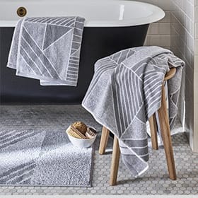 Grey geometric-patterned towels in a bathroom