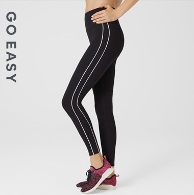 Woman wearing black leggings with side-stripes
