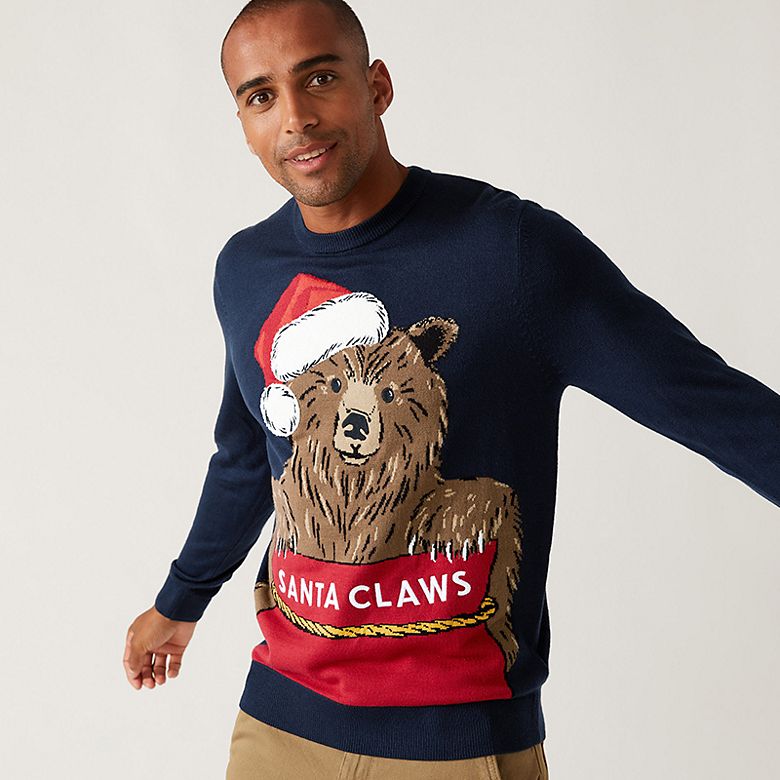 Man wearing novelty Christmas jumper with a bear. Shop men’s Christmas jumpers