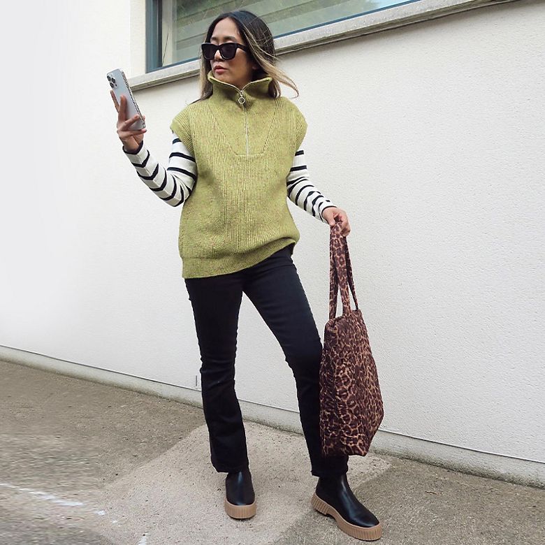 M&S Insider Sam wearing moss-green sweater vest and striped top. Shop women’s knitwear 