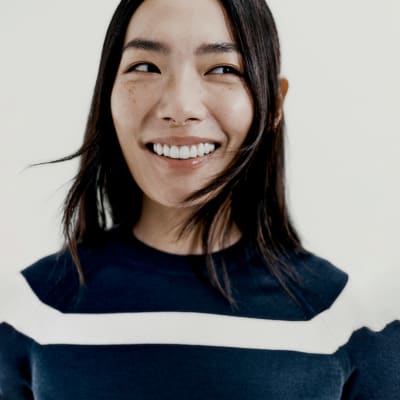 Woman wearing summer capsule wardrobe essentials including a knitted t-shirt. Shop capsule clothing