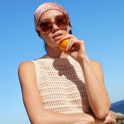 Woman wearing a bandana as an easy summer hairstyle. Shop all haircare 