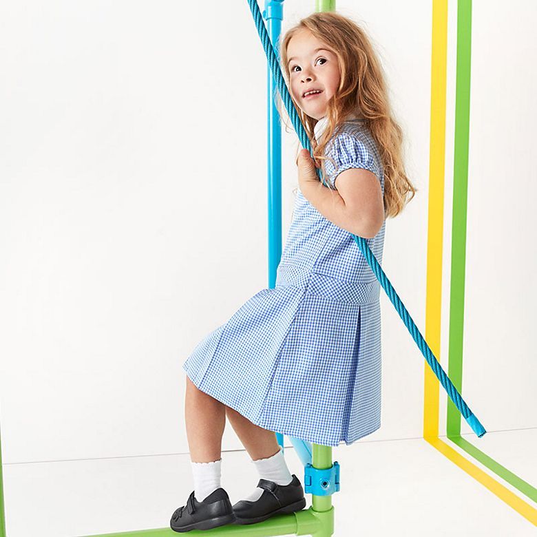 Girl wearing summer school gingham dress and shoes. Shop school uniform 
