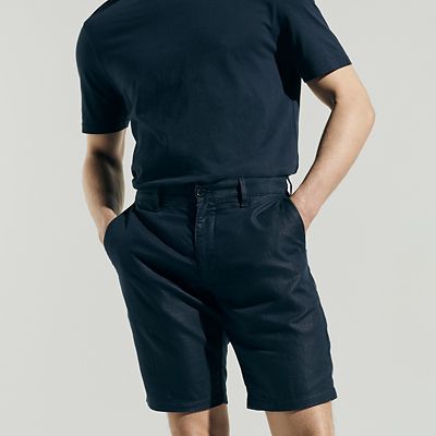 Man wearing summer capsule wardrobe essentials including a shorts. Shop capsule clothing 