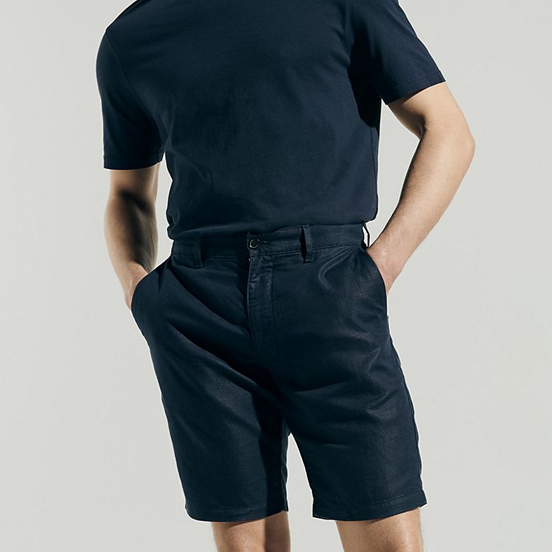 Man wearing summer capsule wardrobe essentials including a shorts. Shop capsule clothing 
