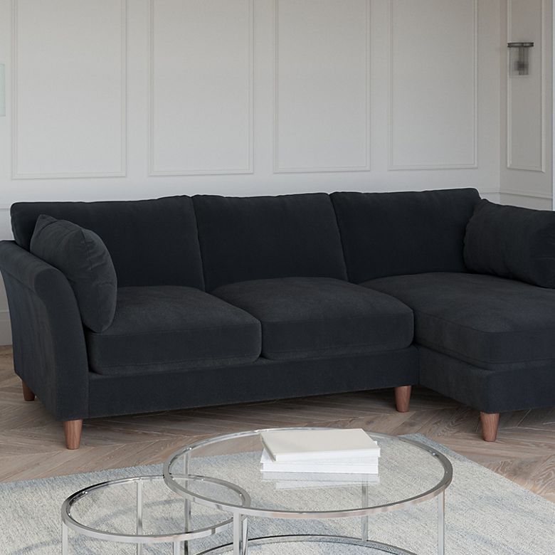Black velvet corner sofa in a living room. Shop sofas 