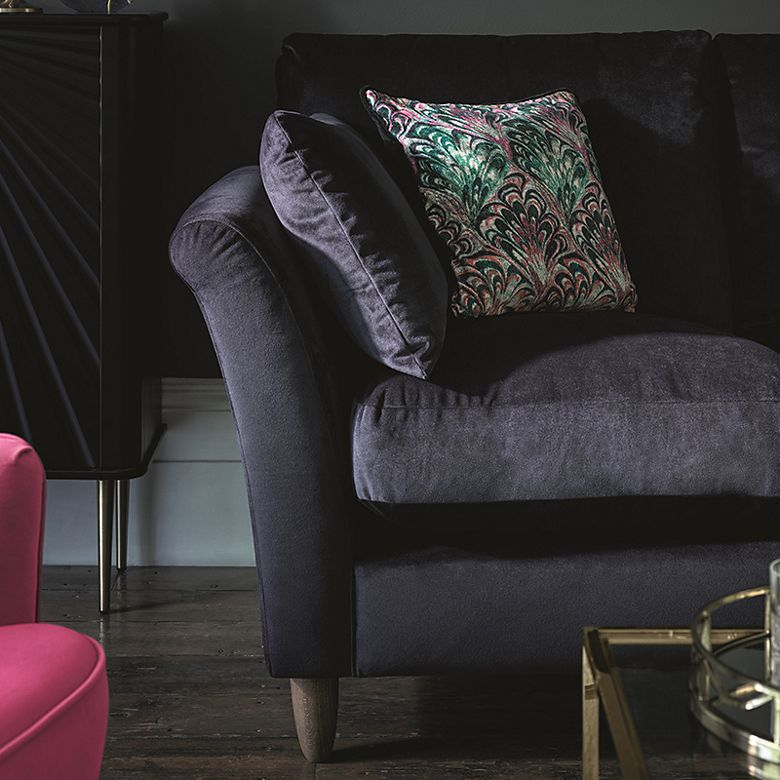 Velvet sofa with decorative cushions. Shop sofas