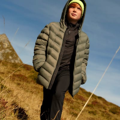 Boy wearing a longline puffer coat. Shop boys’ coats and jackets