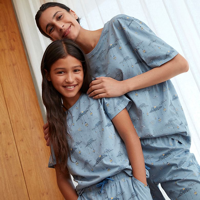 Woman and daughter wearing matching Eid pyjamas. Shop Eid pyjamas 