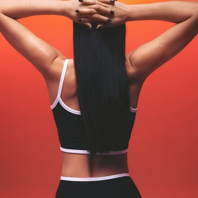 Woman wearing black and white crop top and sports leggings. Shop Beyond Yoga 