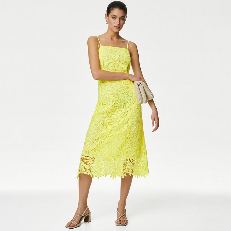 Woman wearing Autograph yellow lace slip dress and strappy cream sandals. Shop slip dresses
