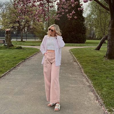 Woman wearing pink striped shirt and pink wide-leg trousers. Shop new-in womenswear 