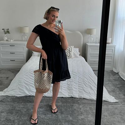 Woman wearing black one-shoulder beach dress. Shop new-in womenswear 