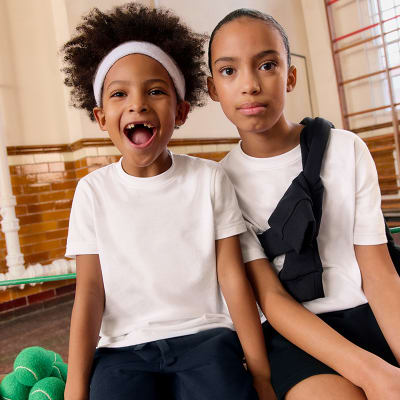 Children wearing assorted school shirts, blouses and polo shirts. Shop school uniform 