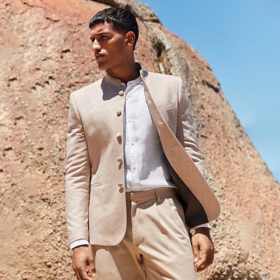 Main wearing beige nehru collar jacket with white shirt. Shop the nehru jacket 