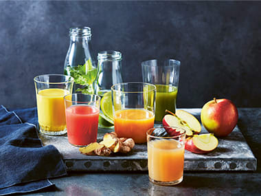 Fresh fruit and glasses of fruit juice