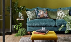 Blue sofa with cushions and footstool