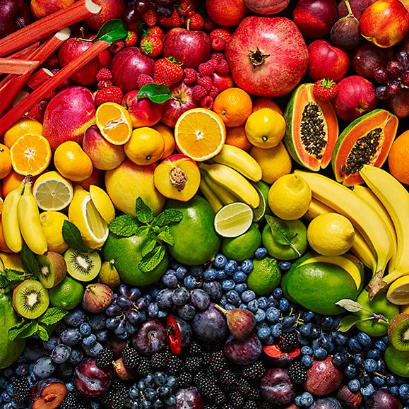 An array of colourful fruit, including citrus fruit, berries, apples and bananas