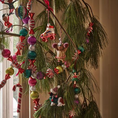 Christmas tree adorned with festive decorations. Shop Christmas trees and decorations now