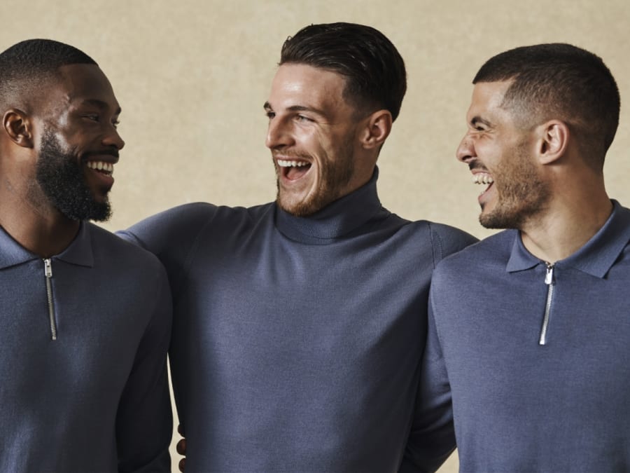 The England Team wearing knitted grey jumpers. Shop now