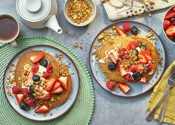 Maple protein pancakes topped with berries, granola and yogurt
