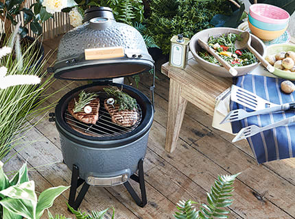 A Weber barbecue with steaks