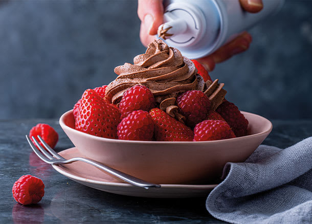 Strawberries and raspberries served with chocolate squrity cream