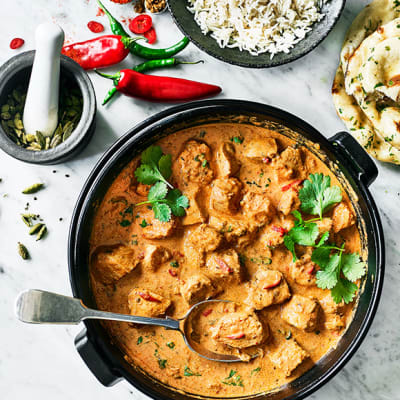 A chicken korma curry with pilau rice and naan bread