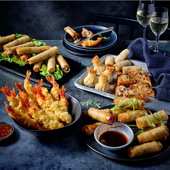 A party food platter with prawn tempura, spring rolls and prawn toasts