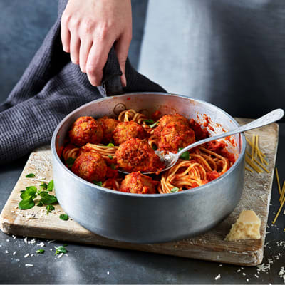 Meatballs served with spaghetti, basil and parmesan