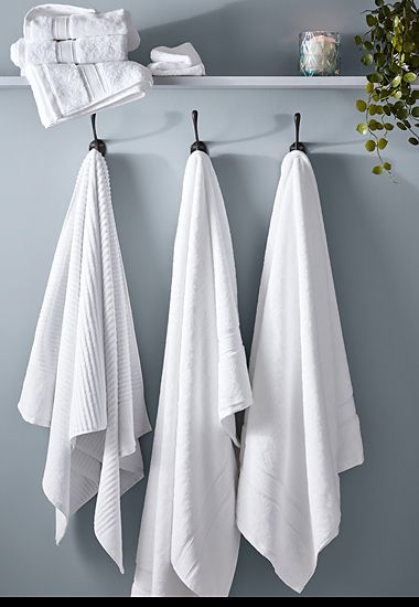 White and grey towels on a towel rack