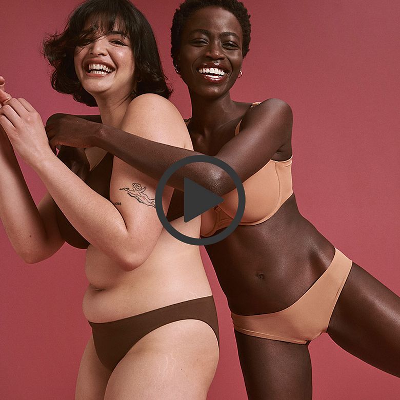 Two women wearing nude lingerie