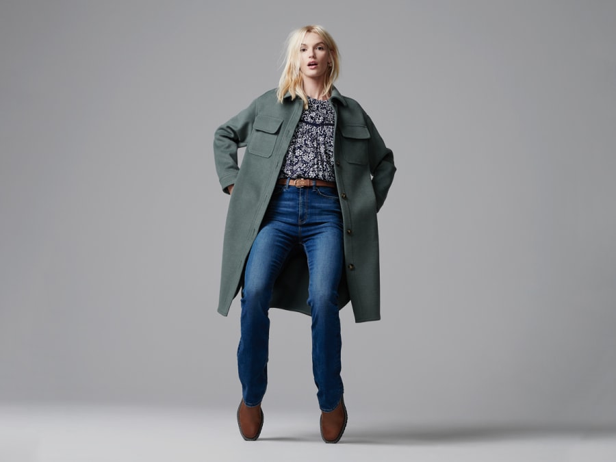 Woman wearing M&S quilted jacket with red hat and jeans